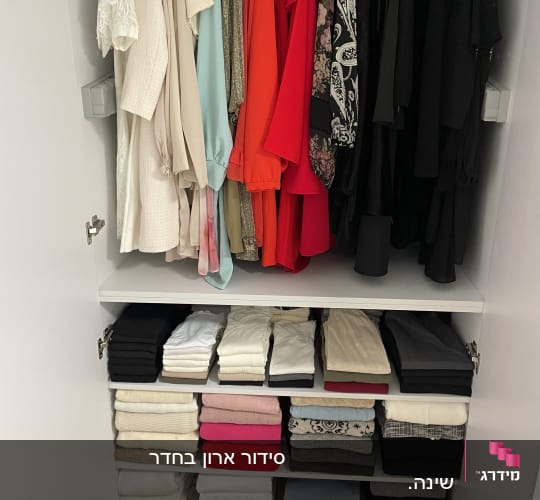 ארון בגדים לבן מסודר ומאורגן בצורה מופתית לפי צבעים